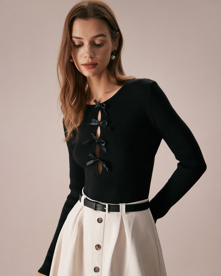 SALE | Dark navy blue top with a boat neckline, bow in front, and knitted texture