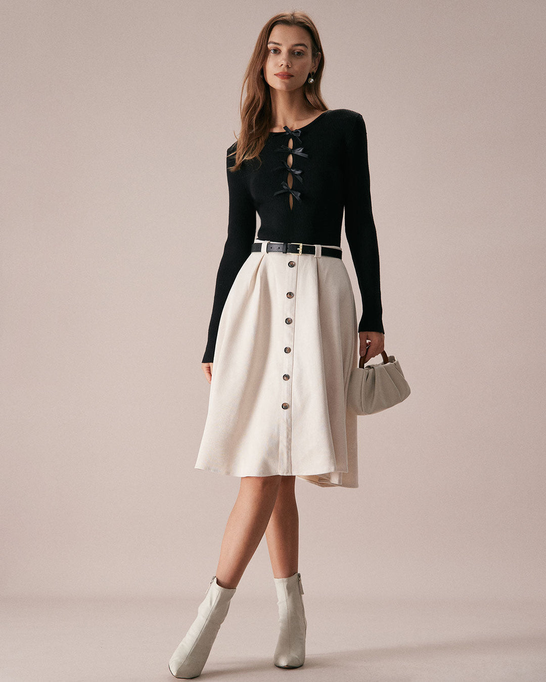 SALE | Dark navy blue top with a boat neckline, bow in front, and knitted texture